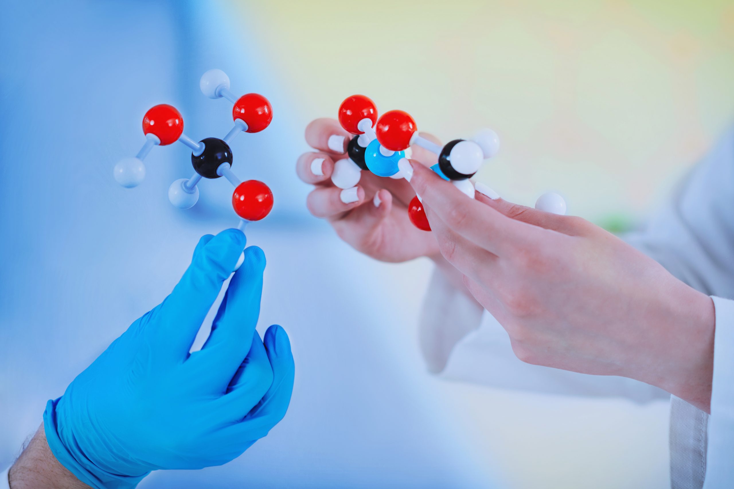 Hands holding molecular structure